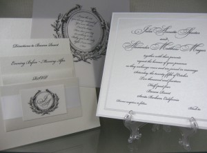 A translucent overlay with crest and poem lay atop a 4-layer 8” square invitation made from pearl and bright white heavyweight cotton