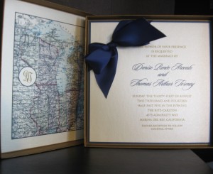 Custom made 8” antique gold frost box holds a 3-layer invite detailed with navy satin bow tucked into the seams